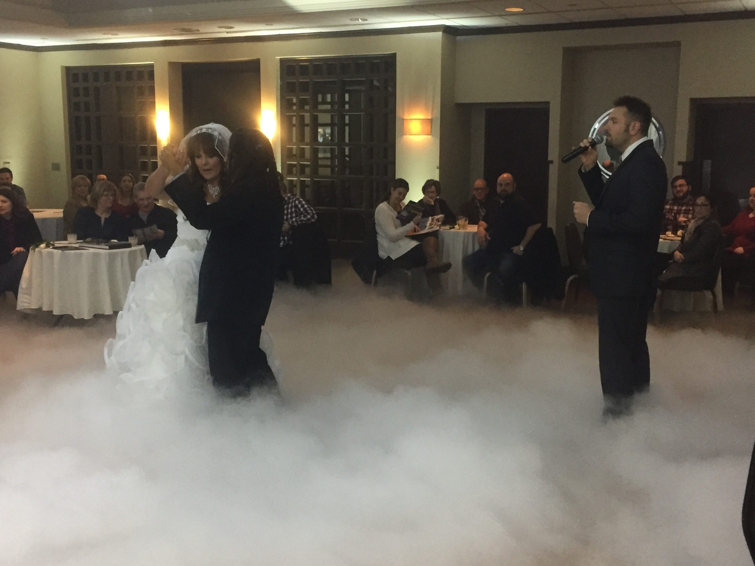 Jay Thomson singing the first dance while our bride and groom dance on the clouds